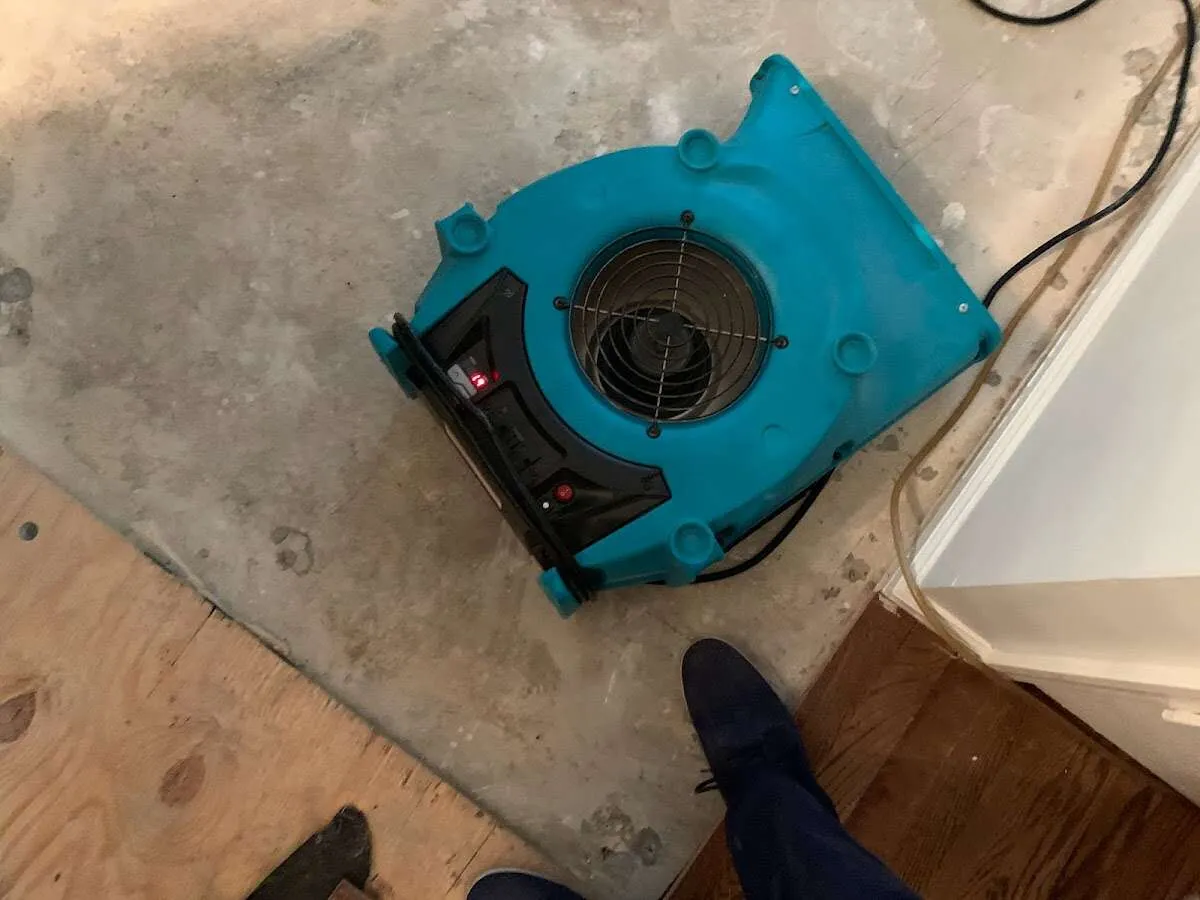 Air mover drying subfloor during Leak Detection & Repair in North Canton